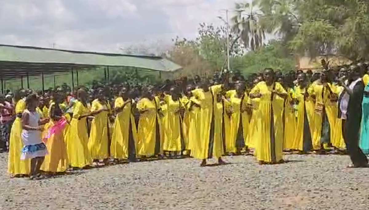Locheria Albert in black suit contacting his Women for Peace Choir at a public event. Credit: Locheria Albert.