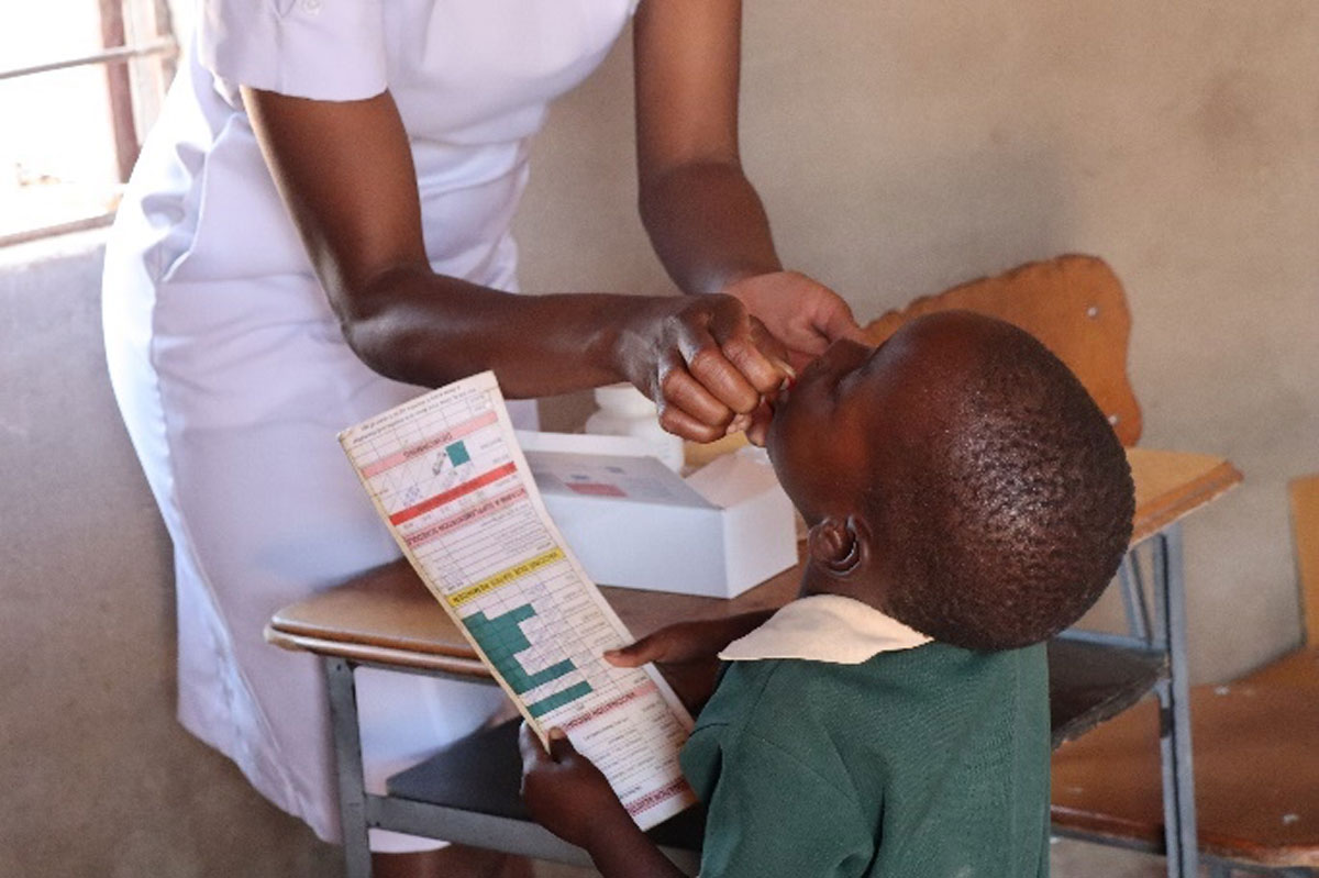 A local nurse administering measles-rubella vaccine and vitamin A supplementation during Zimbabwe's nationwide campaign in October 2025. Credit: WHO Zimbabwe.