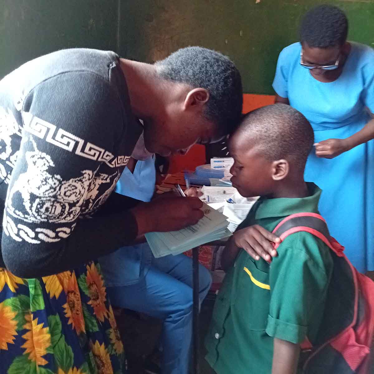 A health worker with a young boy during a measles-rubella vaccination session. Credit: Josephine Chinele 