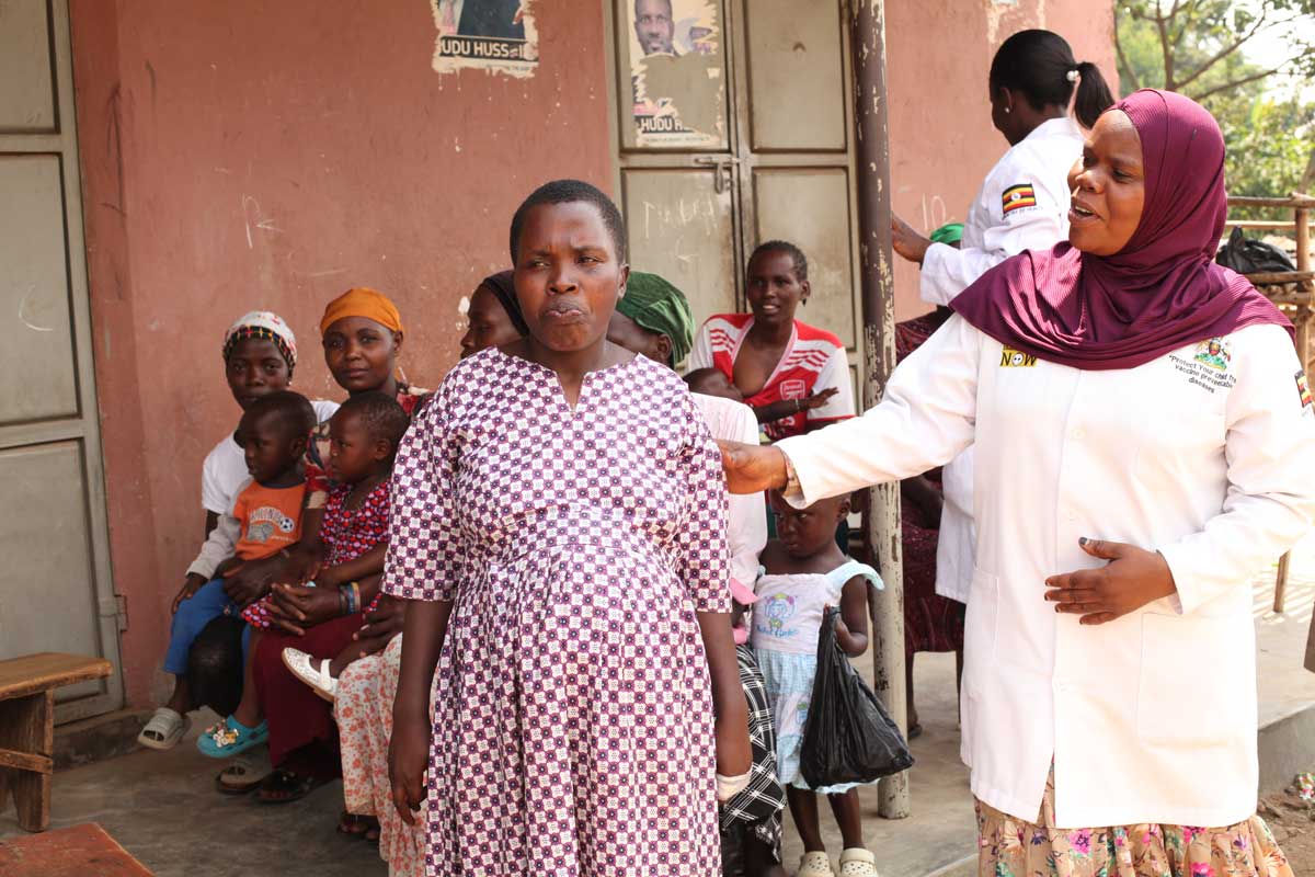 Zaina Namalwa, an enrolled nurse attending to an expecting mother during at outreach. Credit: John Musenze