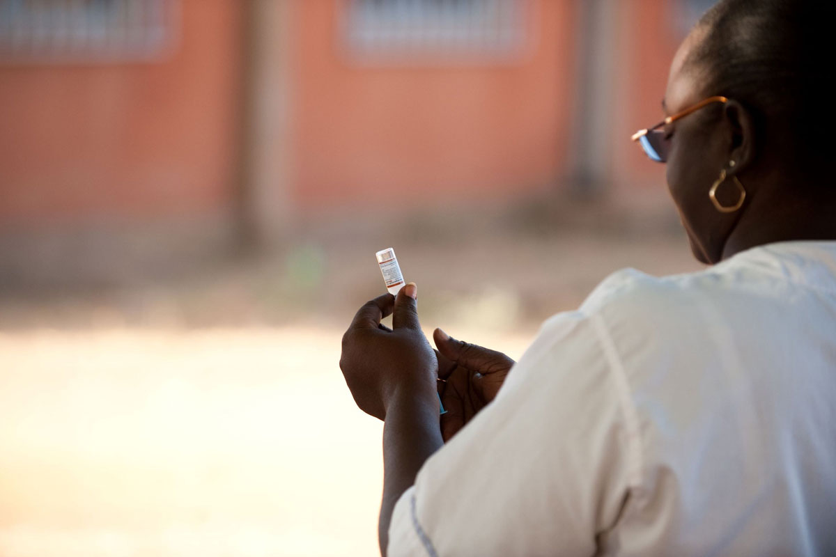 A health care worker prepares a meningitis vaccine. Photo: PATH/Gabe Bienczycki.
