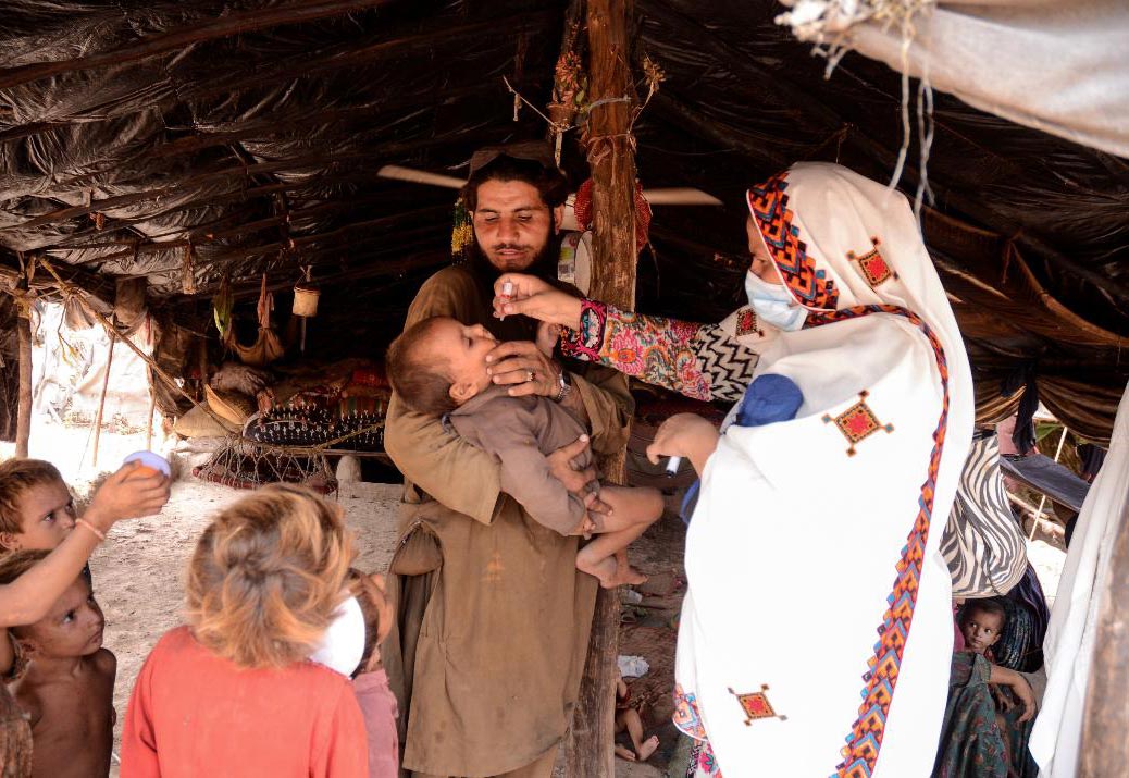 A health worker vaccinates children at a camp in Khyber Pakhtunkhwa. Under the Mobile and Migrant Population initiative health teams seek out such communities to catch up unimmunised children. Photo courtesy: Emergency Operation Centre KP.