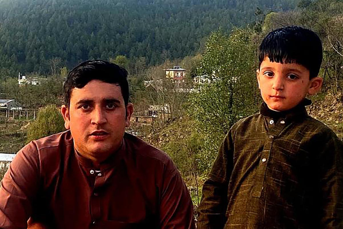 Abdul Ghaffar, founder of the SSPE Foundation WhatsApp group, with his son, Maaz, in their native Battagram district of Khyber Pakhtunkhwa, before Maaz was diagnosed with SSPE.