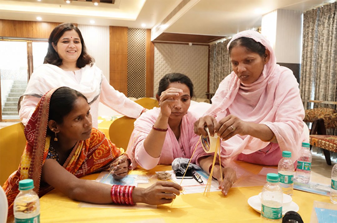 Caregivers and health workers engaged in co-creation workshop activities. Credit: JSI