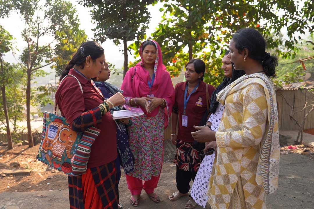 Community health outreach workers meet to plan door-to-door engagement aimed at identifying and counselling families with unvaccinated children. Credit: Amman Shaikh