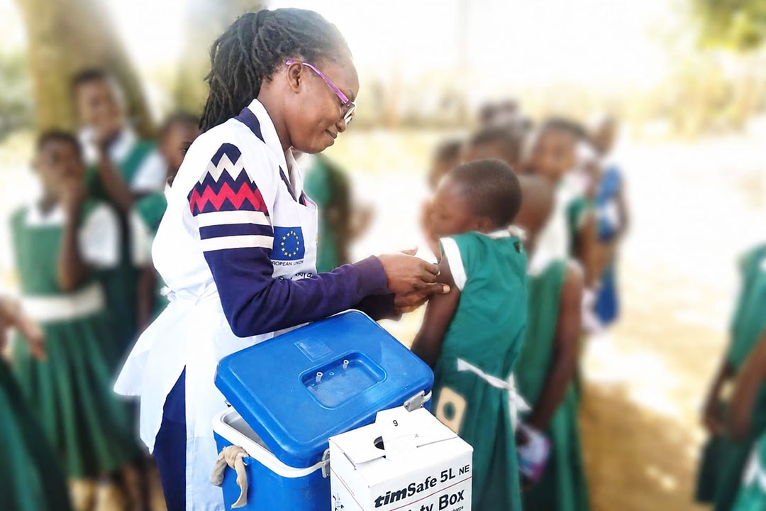 Elizabeth Odhiambo, a nurse at Ambira sub county hospital, administering the HPV vaccine to a 10 years old girl during an outreach in Ngunya school. Credit: Charles Odira
