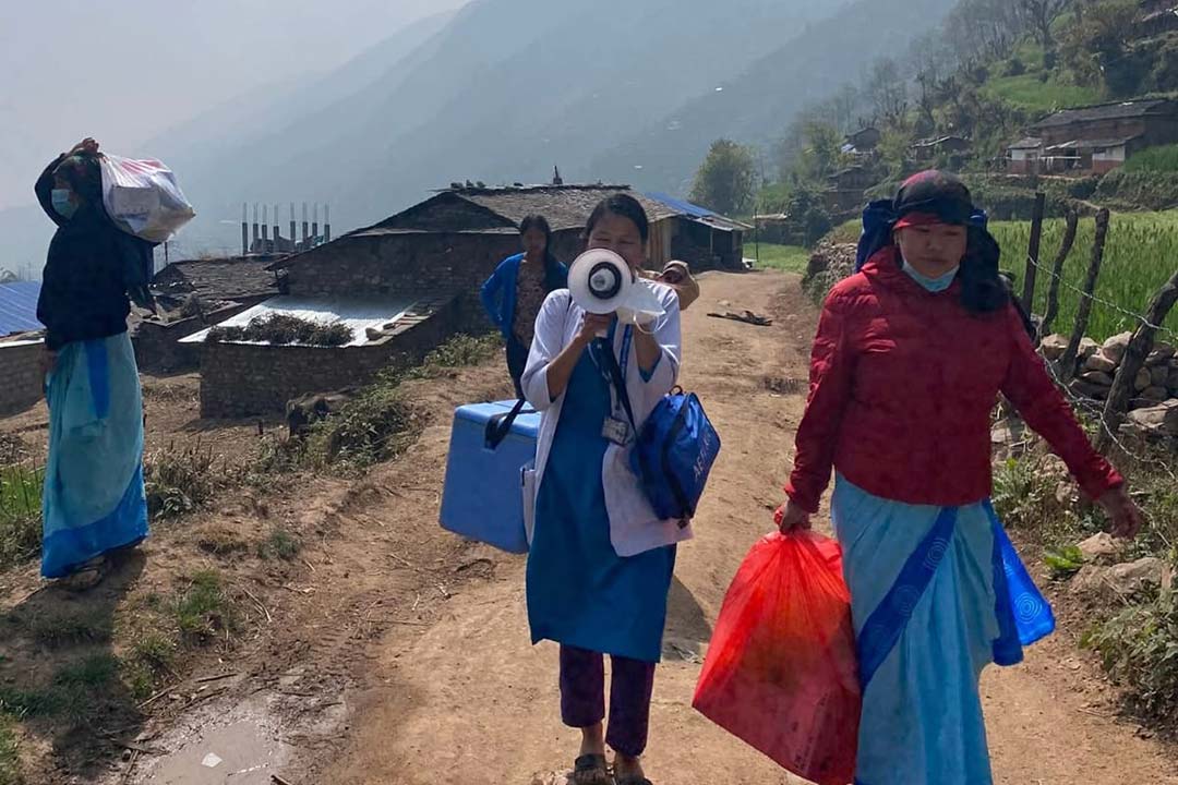 A health worker announces a vaccination session. Credit: Nepal National Immunization Program