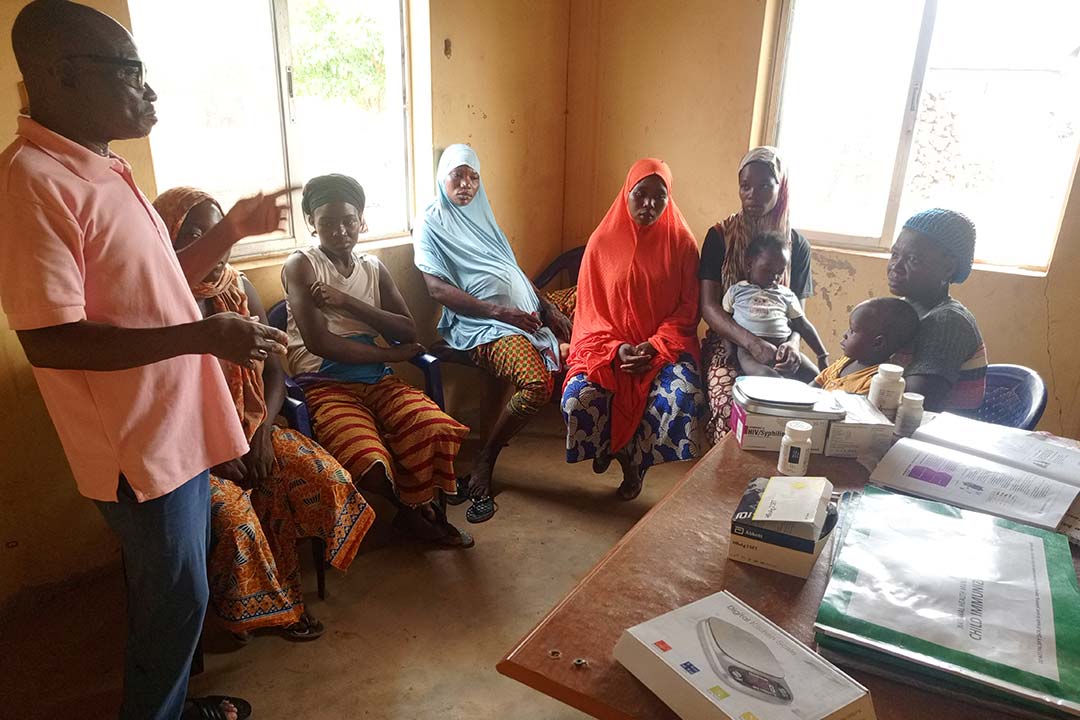 James Tanko sensitising mothers before vaccination. Credit: Afeez Bolaji