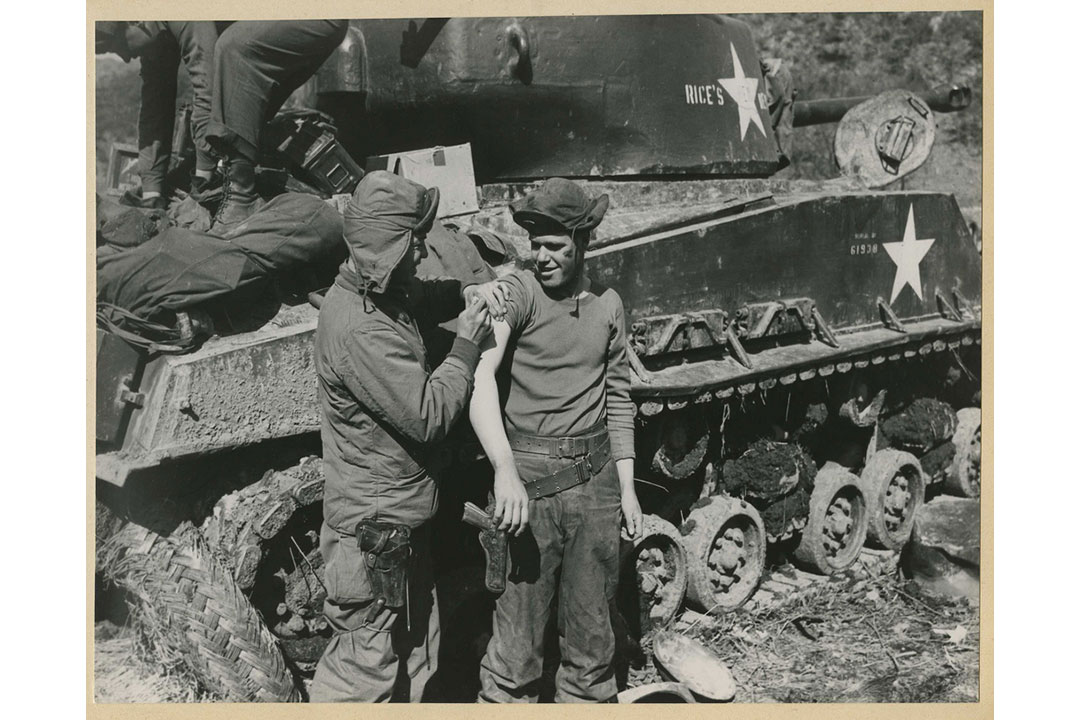 Medic gives a shot to soldier near front line (SC 361229), National Museum of Health and Medicine