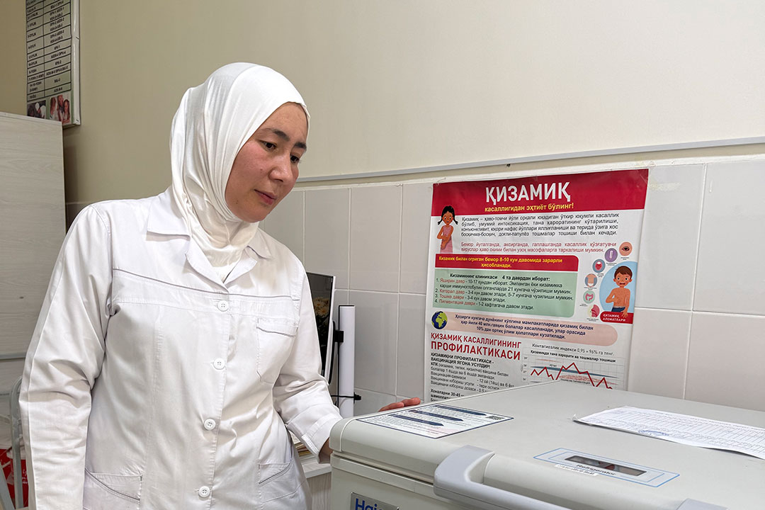 Nilyufar Tursunova shows off her clinic's insulated vaccine refrigerator. Credit: Umida Maniyazova