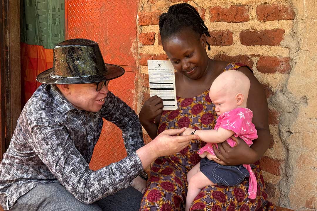 Ogik Peter on left having a light moment with Joanita Namugabo and her son. Credit: John Musenze