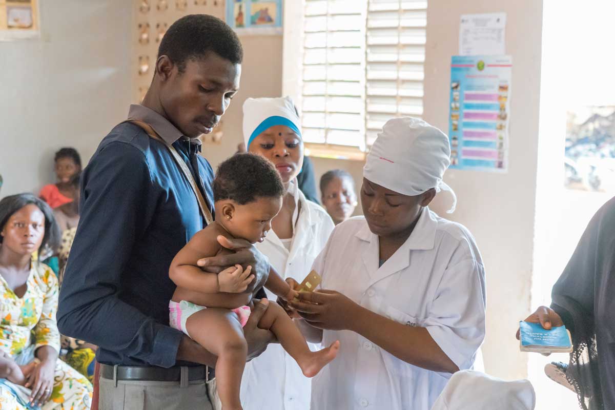 A father and his child at a meningitis vaccination session. Credit:
