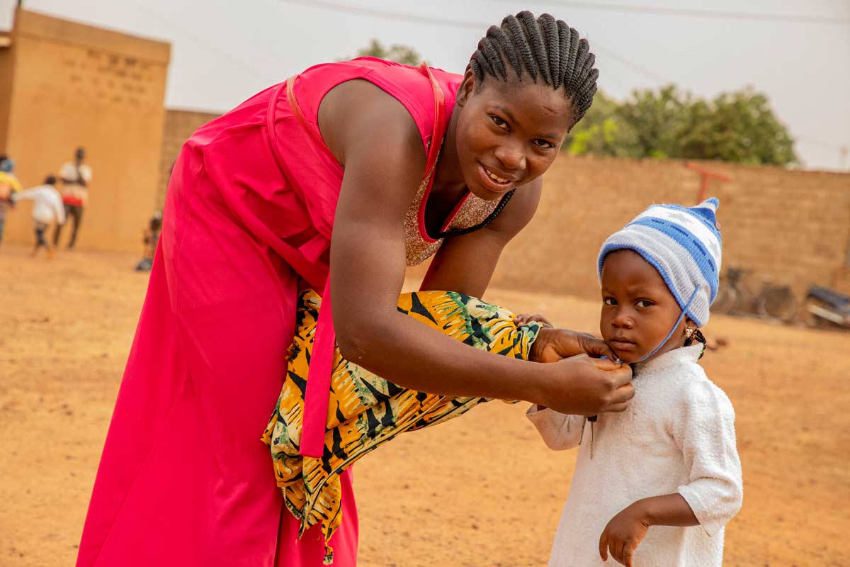 A mother and her child in Burkina Faso during a malaria vaccination session. Credit: Gavi/2024/Arnauld Yalgwueogo