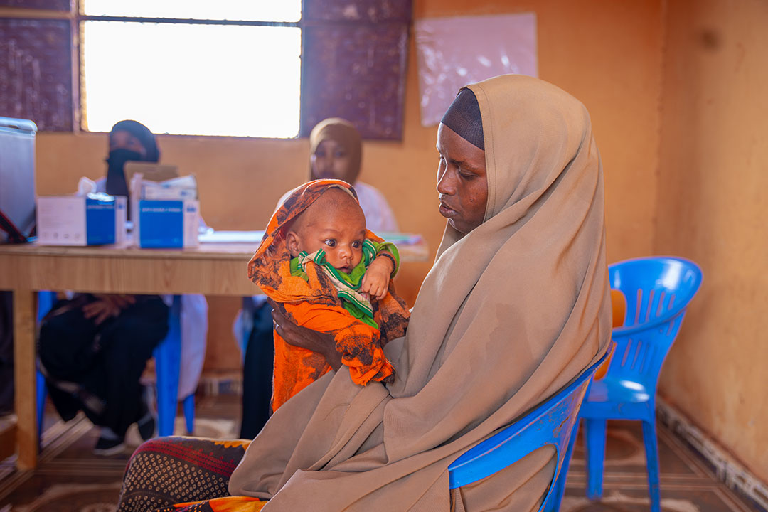Muslima Ahmed holds her child as she waits for him to receive a dose of vaccine at the outreach vaccination facility in Walaag 1 IDP camp. This is part of the Reach Zero Dose Children (ZDC) campaign in Somalia, aimed at identifying vaccinating children who have not received any vaccines, or missed communities by healthcare systems. Gavi/2024/Mohamed Abdihakim Ali
