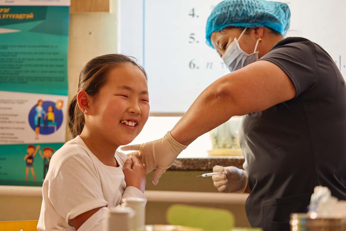 A girl receives the HPV vaccine from a health worker in Mongolia. Credit: Gavi/2024/Khasar Sandag