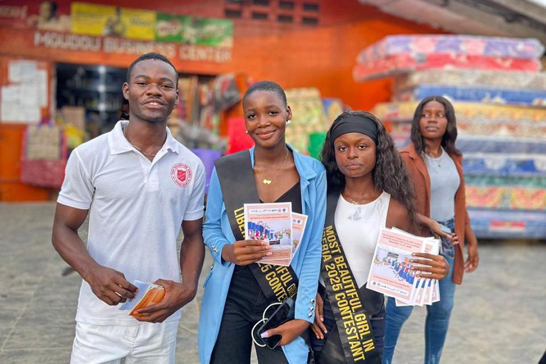 The pageant contestants pause to pose with fans at a local market as they drum up interest in HPV vaccination. Credit: Tina S. Mehnpaine