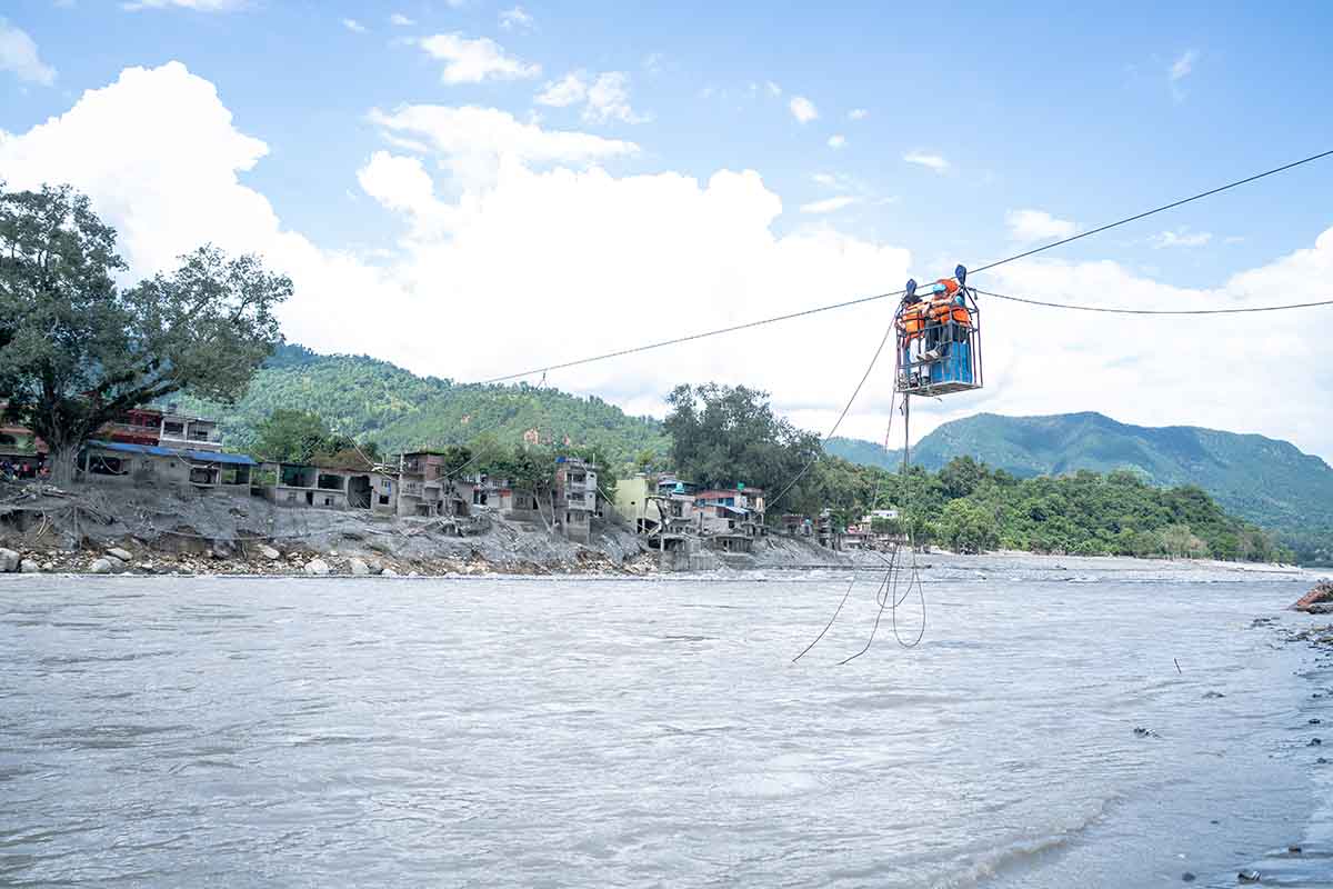 Transporting oral cholera vaccine doses across a fast-flowing river to reach remote communities in rural Nepal. Credit: UNICEF/2026