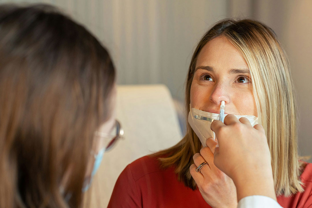 A health care provider administers a nasal vaccine. Photo by CDC on Unsplash