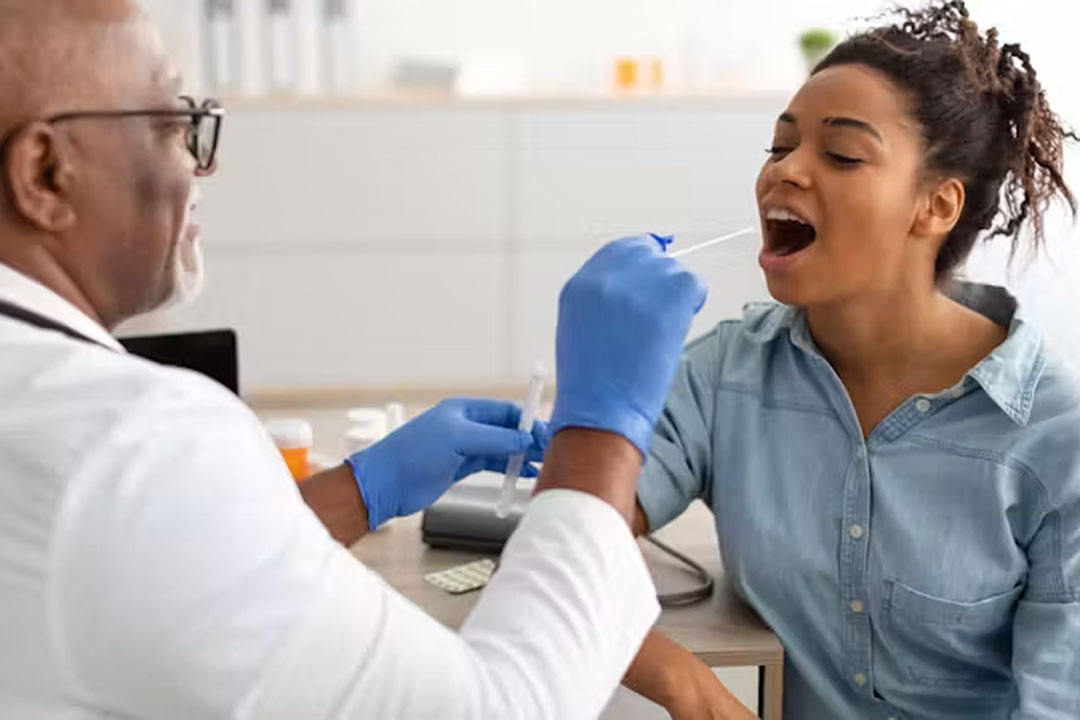 A cheek swab can reveal inherited genetic variants that may influence how someone responds to certain medicines. Prostock-studio/Shutterstock