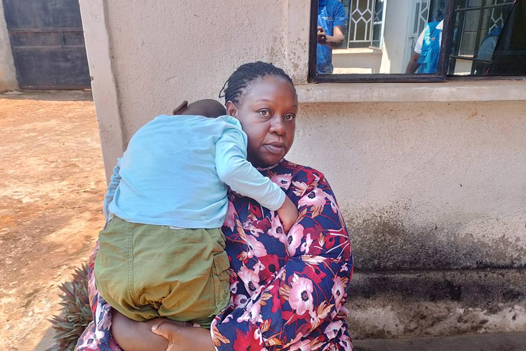 Joshua’s mother holds him outside their home in Busia County, Kenya. Children with disabilities, like Joshua, often go unvaccinated or unsupported by the health system. Recent efforts in Kenya have worked to ensure Joshua and others receive their routine immunisations. Photo credit: PATH/Peter Abwao