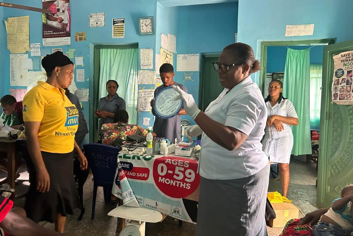 A healthcare worker delivers a health talk to mothers about the importance of routine immunisation and family planning in a PHC in Anambara State. Credit: Parkers Mobile Clinic
