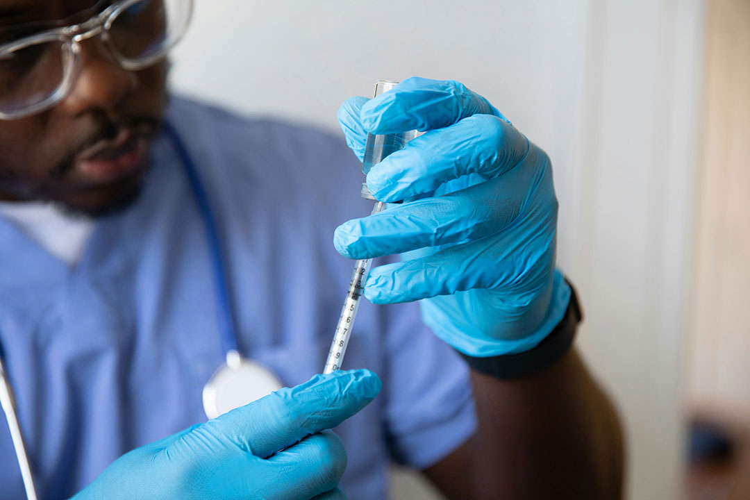 Health worker prepares vaccine injection. Photo by Nappy on Unsplash