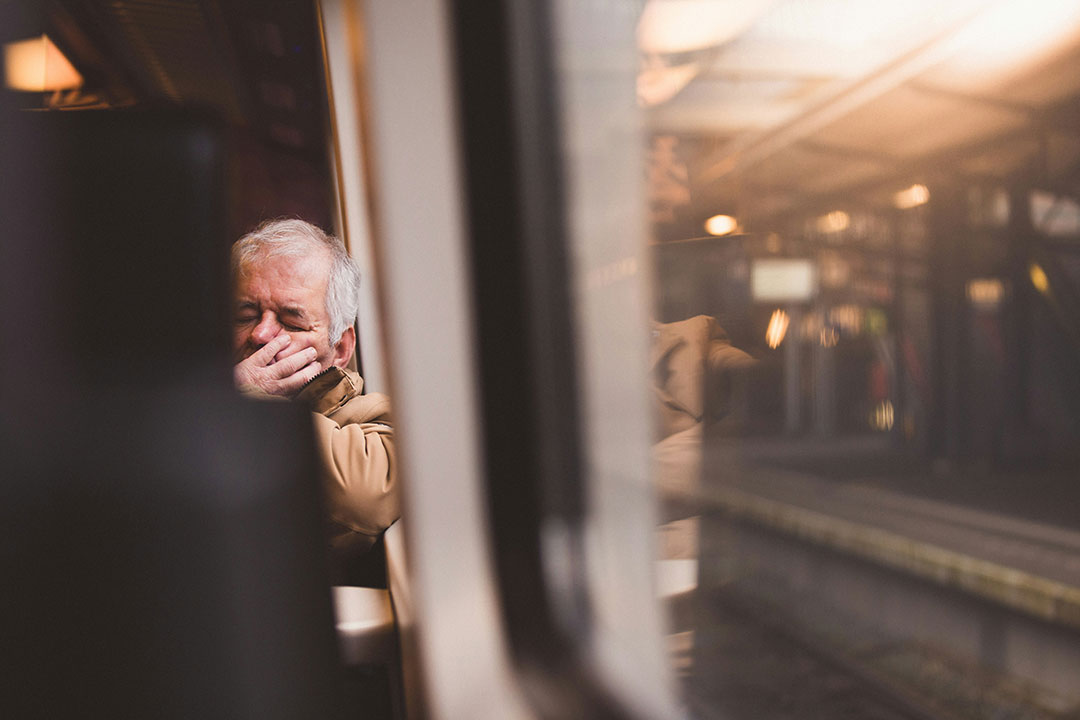 Elderly person sleeping on a train. Photo by Zoë Gayah Jonker on Unsplash