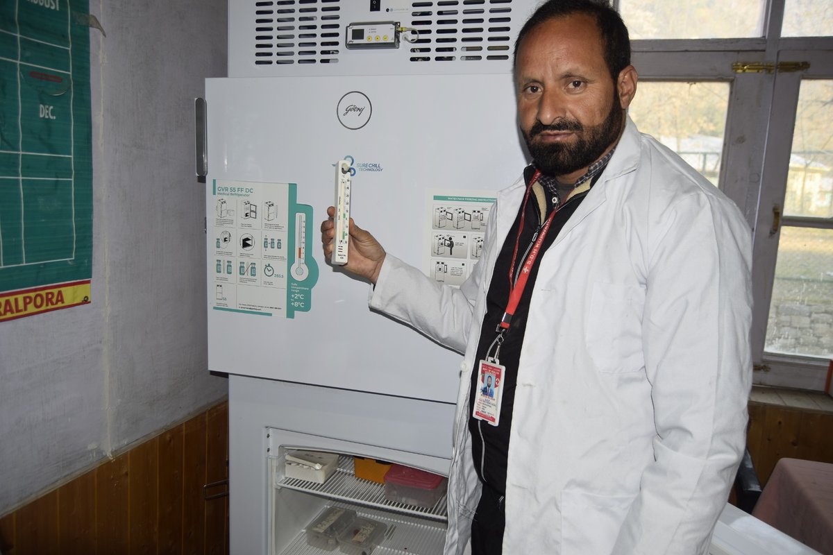 Health officials check the vaccine vials in one of India’s vaccine cold storage terminals in Keran in northern Kashmir.